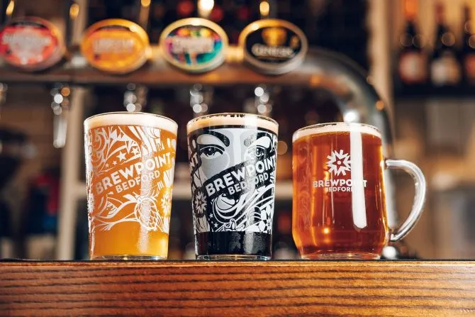 Pub customers posing for a photo whilst watching The Champions Cup at The Bombardier